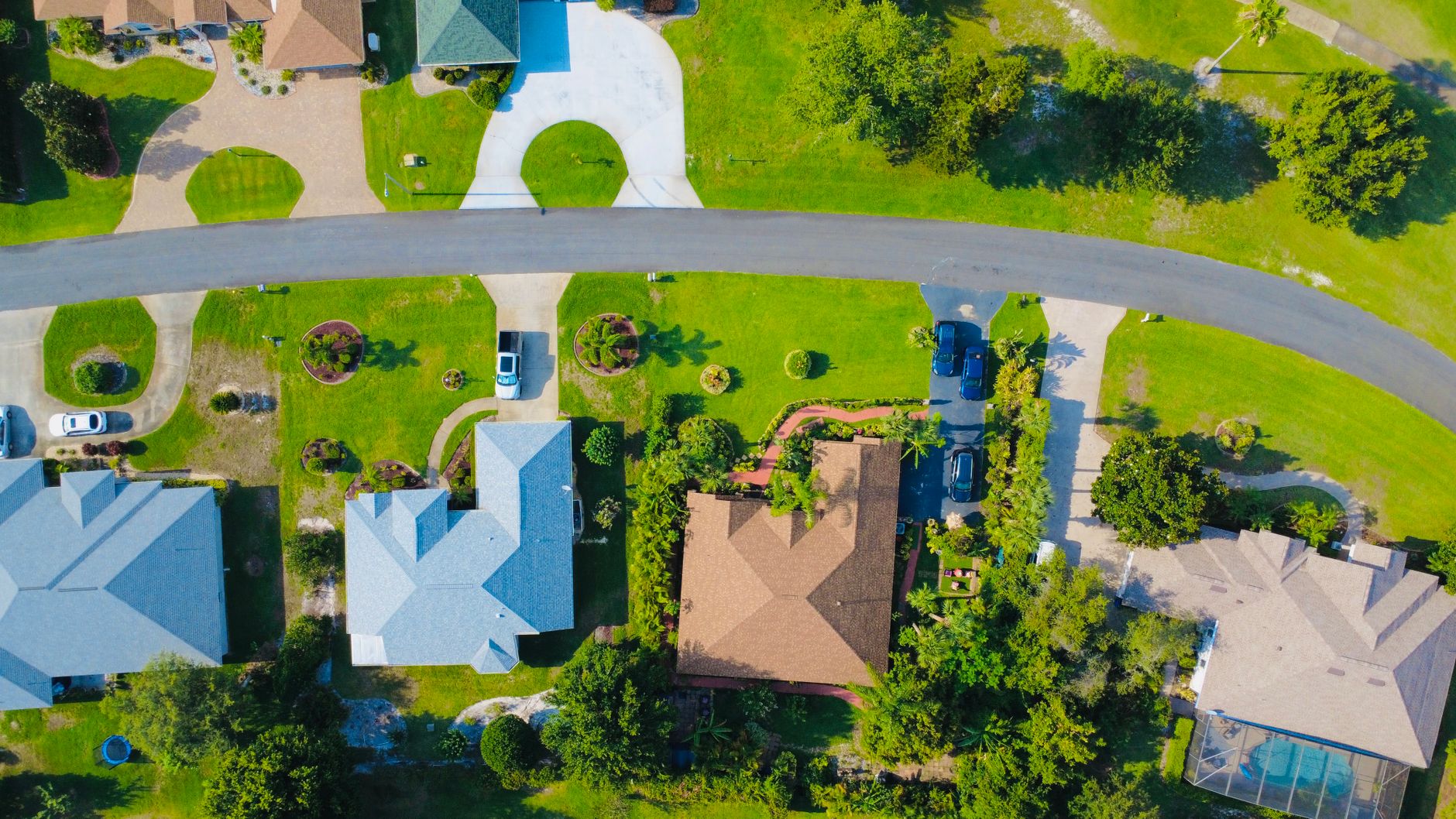 Aerial view of a Port St Lucie suburban neighborhood with well maintained green lawns and driveways