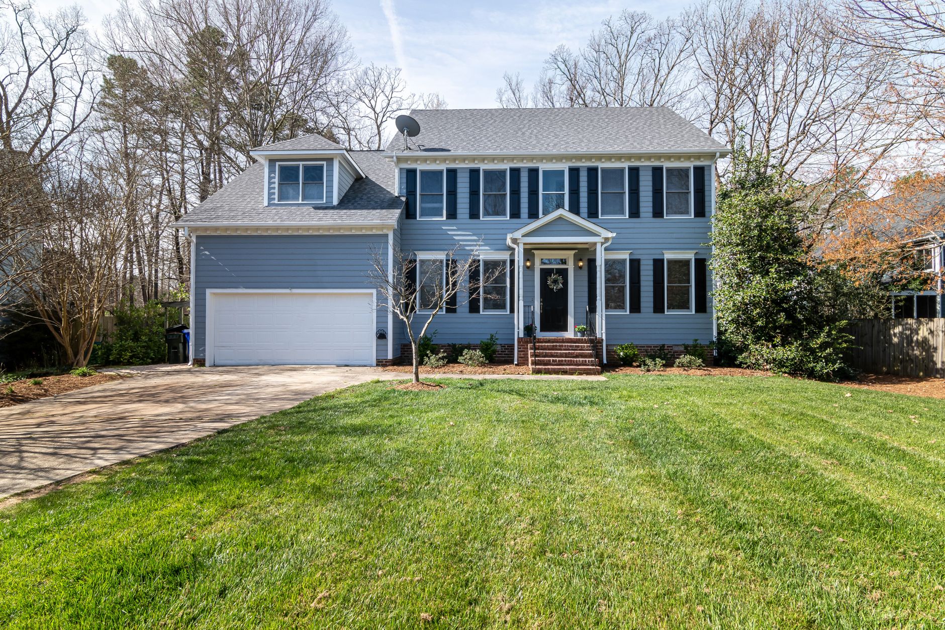Bright suburban family home with a spacious, well kept lawn and classic architecture